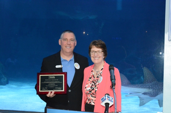 Newport Aquarium Executive Director Eric Rose (left) receives the aquarium's renewed accreditation from Association of Zoos & Aquarium Executive Director Kris Vehrs.